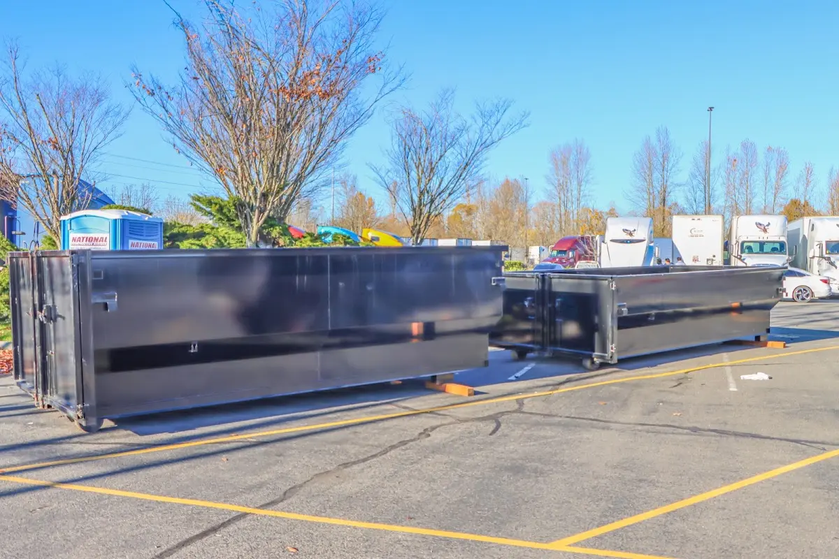 Professional dumpster rental service with roll-off container on residential driveway in Woodcliff Lake